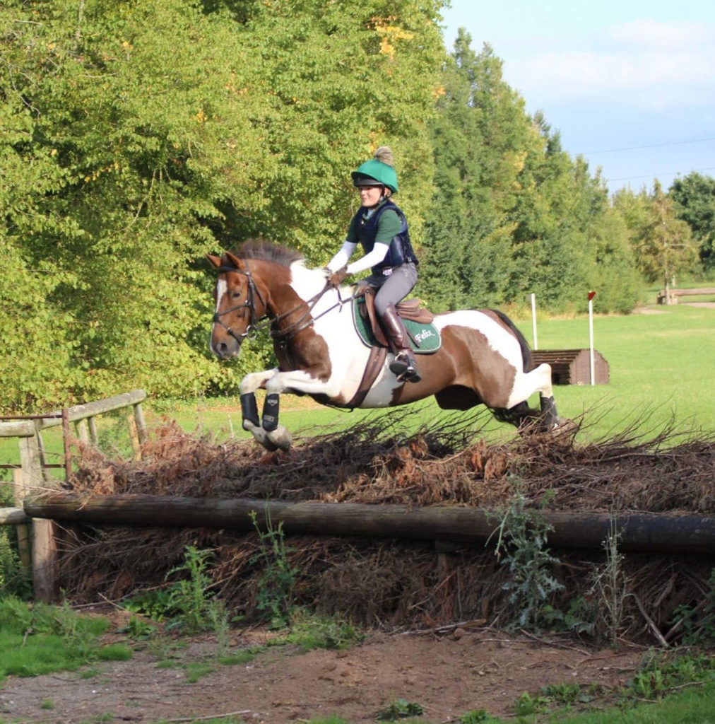 Maisie Randle and horse jumping cross country fence