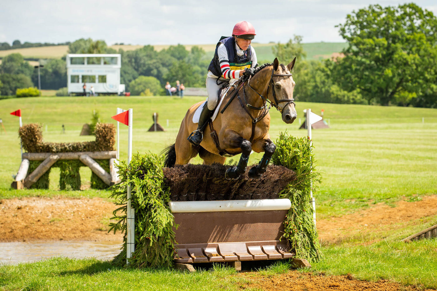 horse and rider jumping cross country jump