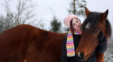 girl with horse in winter